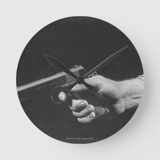 Man Holding Gun Round Clock