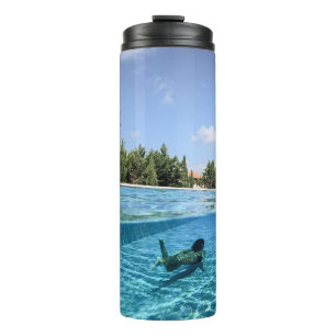 Man in swimming pool in the morning thermal tumbler