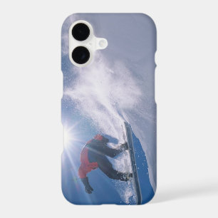 Man jumping off a large cornince on a snowboard