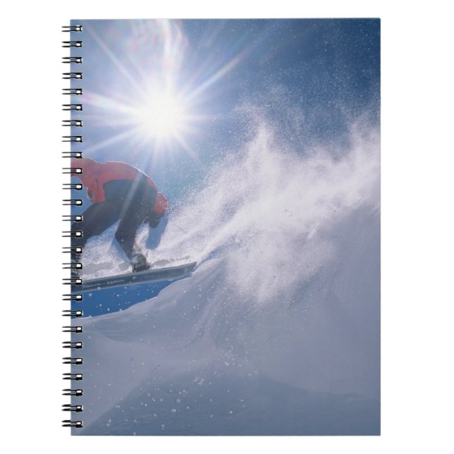 Man jumping off a large cornince on a snowboard notebook (Front)