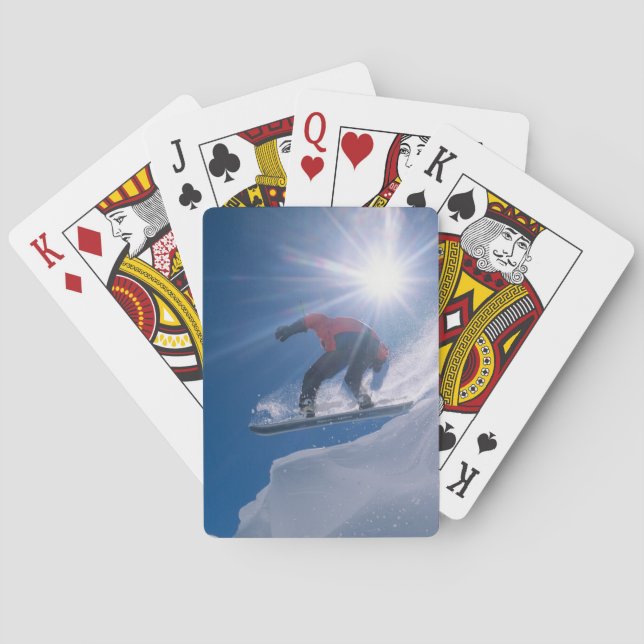 Man jumping off a large cornince on a snowboard playing cards (Back)