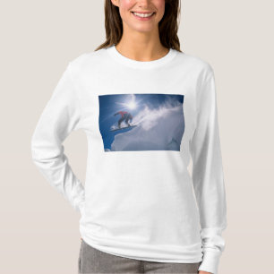 Man jumping off a large cornince on a snowboard T-Shirt