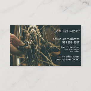 Man makes adjustments on bike wheel business card