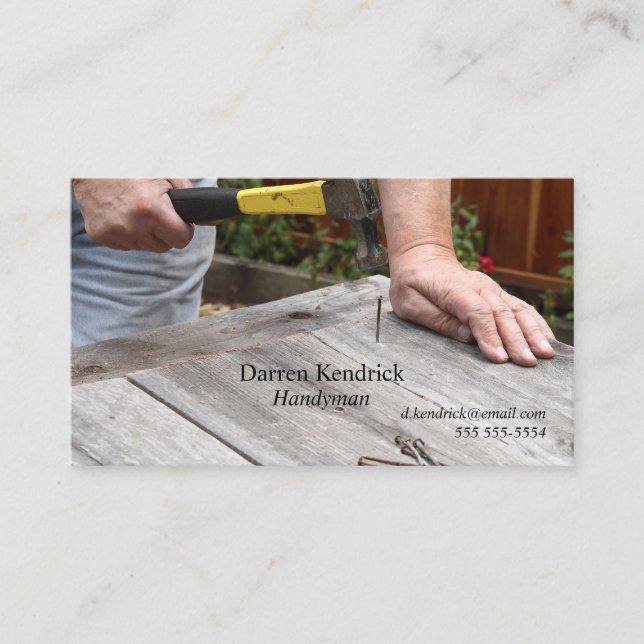 Man nails boards in backyard business card (Front)