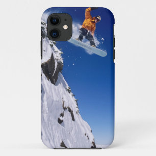 Man on a snowboard jumping off a cornice at iPhone 11 case