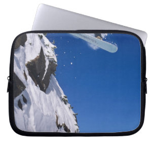 Man on a snowboard jumping off a cornice at laptop sleeve
