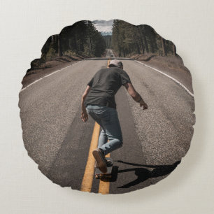 Man playing skateboard on road in the morning round cushion