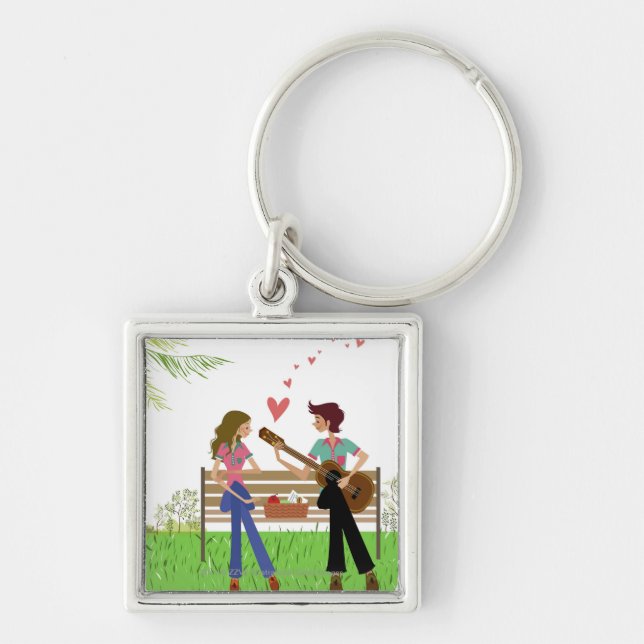 Man playing the guitar with a woman beside her key ring (Front)