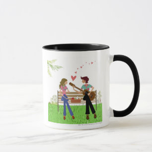 Man playing the guitar with a woman beside her mug
