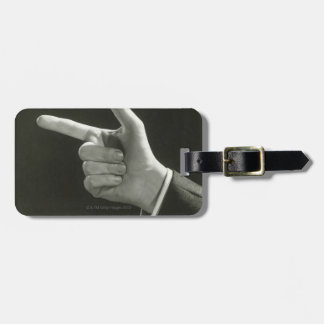 Man Pointing Luggage Tag