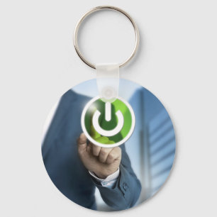 Man pushes power button concept background key ring