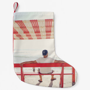 Man sitting on bench near beach small christmas stocking