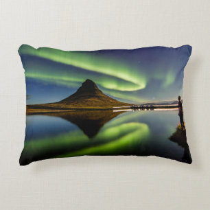 MAN STANDING BESIDE THE BODY OF WATER WITH AURORA DECORATIVE CUSHION