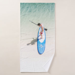 Man surfing on beach bath towel