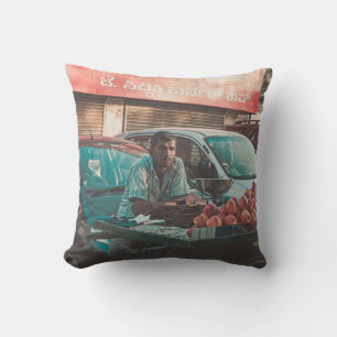 MAN VENDING APPLES NEAR PARKED CARS CUSHION