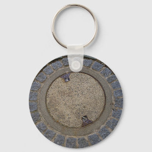Manhole cover and cobblestone road keychain