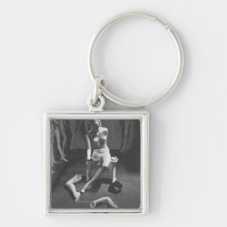 Mannequin with leg and arm removed key ring