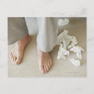 Man's feet surrounded by crumpled tissues postcard
