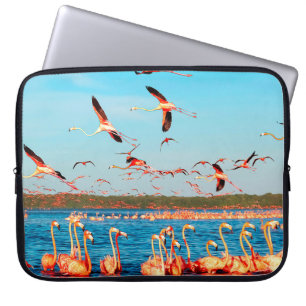 Many pink beautiful flamingos in a beautiful blue laptop sleeve