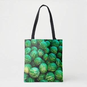 Many watermelons on the market background tote bag