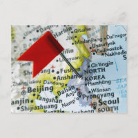Map pin placed on North Korea on map, close-up