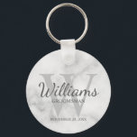 Marble Personalised Script Groomsmen Key Ring<br><div class="desc">Add a personal touch to your wedding with personalised groomsmen keychain. This keychain features personalised groomsman's name in grey classic script font style with wedding details in grey classic serif font style and monogram in light grey classic serif font style as background, on white marble background. Also perfect for best...</div>