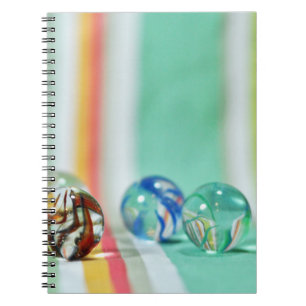 Marbles on a striped background notebook