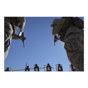 Marines change magazines in the midst of firing photo print