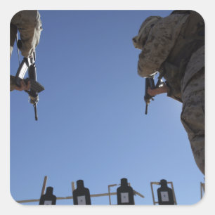 Marines change magazines in the midst of firing square sticker