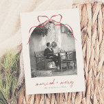 Married & Merry Elegant Bow Arch Photo Holiday Card<br><div class="desc">Celebrate your first holiday season as newlyweds with these elegant Christmas photo cards. Send heartfelt holiday greetings with classic folded Christmas cards. This timeless format gives you more space for a personal message. The design highlights an arch-shaped photo topped with a whimsical hand-drawn bow, with ‘married merry’ in modern script...</div>
