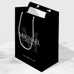 Masculine Black Personalised Groomsmen Medium Gift Bag<br><div class="desc">Add a personal touch to your wedding with personalised groomsmen gift bag. This gift bag features personalised groomsman's name with title and wedding date in white and monogram in grey as background, in classic serif font style, on black background. Also perfect for best man, father of the bride, ring bearer...</div>