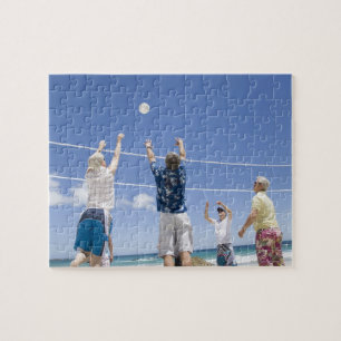 Mature men leaping for volley ball on beach, jigsaw puzzle