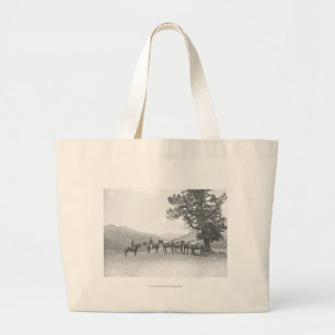 Men with packhorses looking over a hill large tote bag