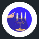 Menorah on Blue Classic Round Sticker<br><div class="desc">Golden menorah being lit for Hanukkah with a Star of David and a gold background.</div>