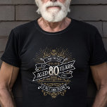 Mens Funny Whiskey 80th Birthday T-Shirt<br><div class="desc">Celebrate the big 8-0 with style and humour with this vintage whiskey label-inspired birthday design. The black, gold, and white typography is ornate and elegant, giving it a classic retro vintage feel. Perfect for man (or woman!) in your life who loves their scotch, spirits, bourbon, and other liquor drinks. Features...</div>