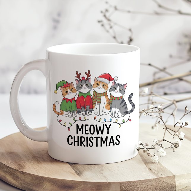 Meowy Christmas Funny Cat - Holiday Cat Lovers Coffee Mug (Meowy Christmas Funny Cat Holiday Mug for Cat Lovers on a wooden kitchen table.)