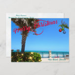 Merry Christmas from Vero Beach Florida Oceanfront Holiday Postcard<br><div class="desc">Merry Christmas from Vero Beach, Florida! This colourful tropical-themed postcard features a photo image of a beautiful Vero Beach oceanfront area all decked out for the holidays. The festive design includes Christmas lights on the greenery, Christmas balls hanging from a palm frond, and the text "Merry Christmas" in red script...</div>