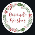 Merry Christmas in Afrikaans Geseënde Kersfees Classic Round Sticker<br><div class="desc">Green and red Christmas holiday wreath design stickers for decorating gifts and envelopes,  with the words Merry Christmas in Afrikaans: Geseënde Kersfees</div>
