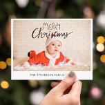 Merry Christmas modern simple photo Holiday Postcard<br><div class="desc">Send this simple and modern Christmas postcard to your family and friends. This Christmas card is personalizable by adding one of your favourite photos, your family name, and year, and features a trendy overlay text that reads "Merry Christmas" in modern handwritten fonts. The back of the card is customisable with...</div>