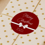 Merry Christmas Ribbon Handwritten Modern Red Classic Round Sticker<br><div class="desc">Add the finishing touch to your gift packaging this holiday season with these elegant red and white Christmas round stickers. Featuring handwritten style font that reads 'Merry Christmas',  a hand drawn whimsical bow in white with your custom name underneath.</div>