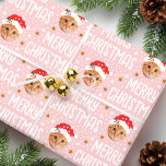 Merry Christmas Santa Photo Cute Face Pink Wrapping Paper<br><div class="desc">Make your gifts stand out this holiday season with custom photo wrapping paper! This fun face-in-a-hole template is personalised with a favourite photo, and features a festive Santa Claus hat, complete with snowflakes, stars, and the greeting "Merry Christmas" in a cheerful font. It's a simple, stylish design, perfect for pictures...</div>