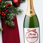 Merry Christmas Script Red Ribbon Bow Wine Label<br><div class="desc">Chic,  modern cursive script across a gorgeous red ribbon and bow reads MERRY CHRISTMAS in elegant cursive typography. A tied bow is super trendy for 2025 holiday party champagne bottle labels. Personalise with your family or business name in the centre.</div>