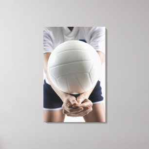 Mid section view of a young woman serving a canvas print