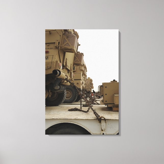 Military vehicles are locked down on semi truck canvas print (Front)