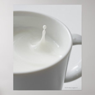 Milk splashing in cup poster