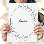 Minimalist Black Leaf Wreath Custom Name Planner<br><div class="desc">This elegant design features a minimalist black line-drawn wreath of delicate leaves encircling a customisable name in a stylish script. The clean and modern aesthetic makes it perfect for professionals, students, or anyone who appreciates simple and sophisticated designs. Ideal for organising tasks, journalling, or planning with a touch of understated...</div>