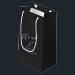 Minimalist Black Script Bridal Shower Thank You Small Gift Bag<br><div class="desc">This bridal shower gift bag features soft script lettering on a classic black background for a timeless, elevated look. The minimalist design pairs beautifully with modern, formal, or monochrome bridal shower themes while keeping the focus on thoughtful presentation. A polished finishing touch that complements elegant bridal shower décor without feeling...</div>