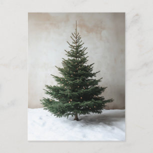 Minimalist Christmas Tree with Soft Lights on Snow Postcard