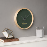 Minimalist dark green gold script personalised clock<br><div class="desc">The minimalist dark green gold script personalised is a chic and refined design that adds a touch of luxury. With its sleek dark green background and elegant gold script,  it combines minimalist design with personalised detailing for a stylish and sophisticated gift.</div>