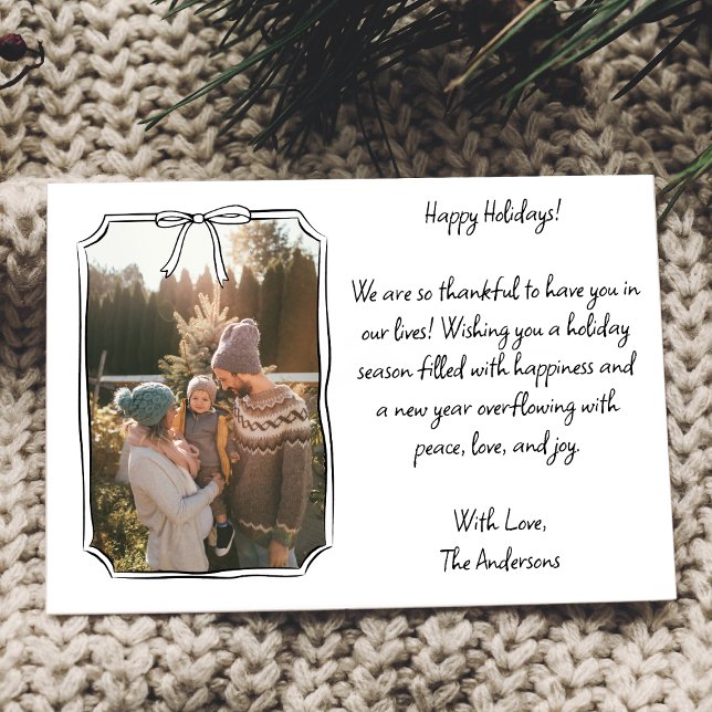 Minimalist Simple Bow Black and White Family Photo Holiday Card (Frame your family memories with this chic, customizable holiday card featuring a hand-drawn bow.)